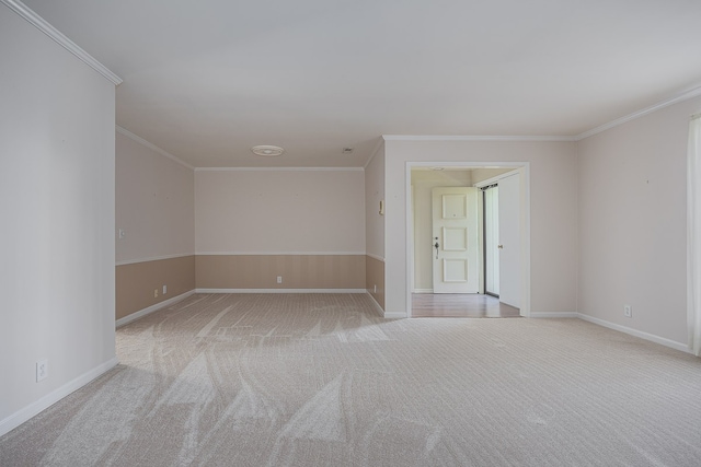 unfurnished room with crown molding and light carpet