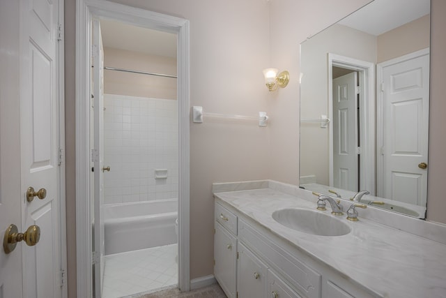 bathroom with tile patterned floors, vanity, and tiled shower / bath