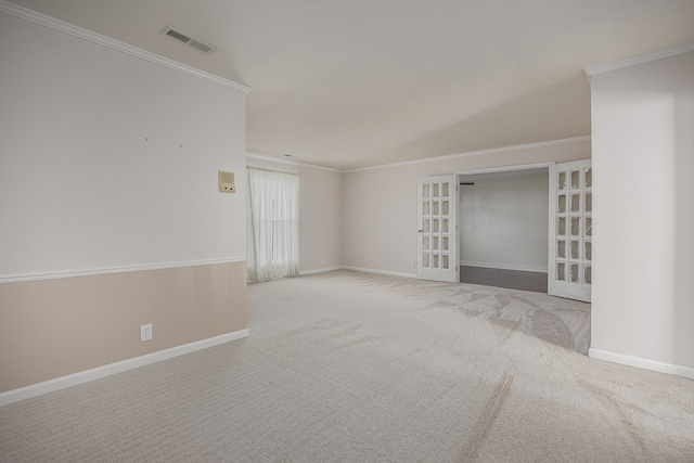 empty room with ornamental molding, carpet floors, and french doors