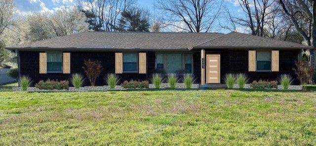 ranch-style home with a front lawn