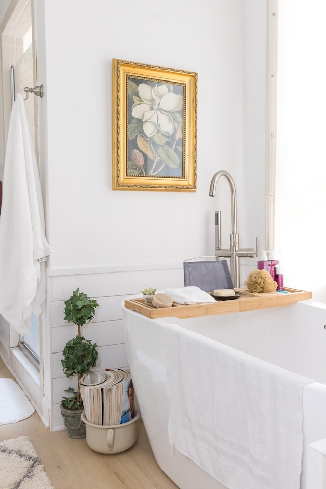 bathroom with hardwood / wood-style flooring and separate shower and tub