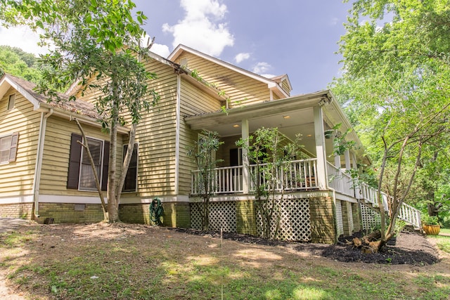 back of house featuring covered porch