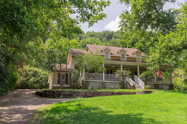 view of front of property with a porch and a front lawn