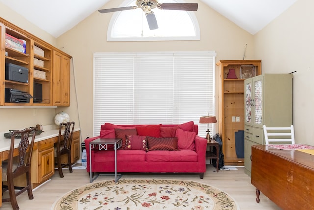 living room featuring lofted ceiling, light wood-type flooring, and ceiling fan