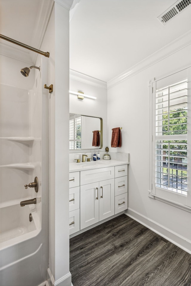 bathroom with vanity, bathtub / shower combination, wood-type flooring, and a wealth of natural light