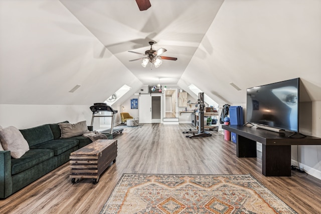 living room with ceiling fan, wood-type flooring, and vaulted ceiling