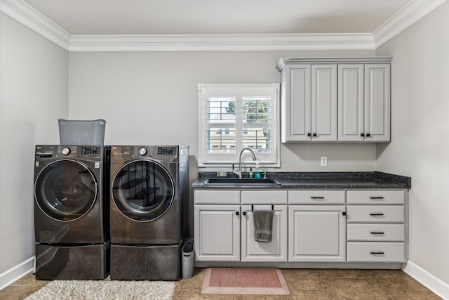 laundry area featuring washing machine and dryer, sink, crown molding, cabinets, and tile patterned flooring