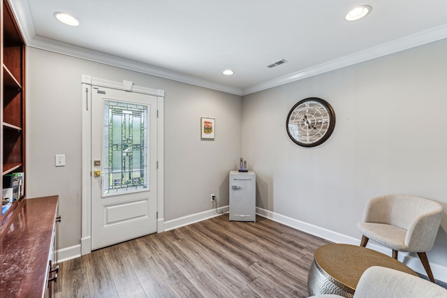 living area featuring crown molding and wood-type flooring