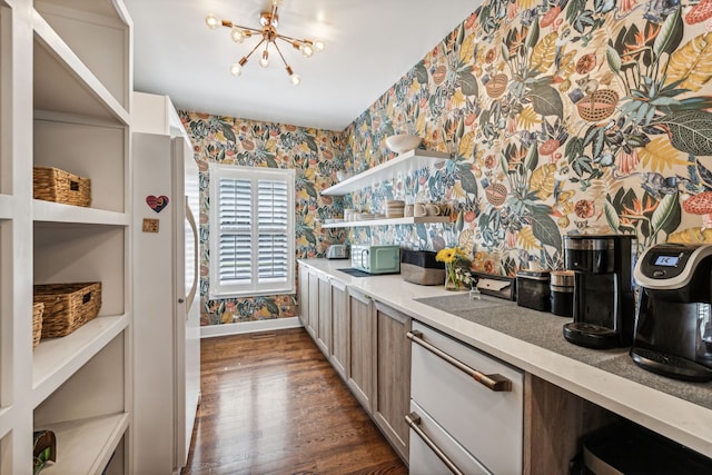 kitchen with a notable chandelier and dark hardwood / wood-style flooring