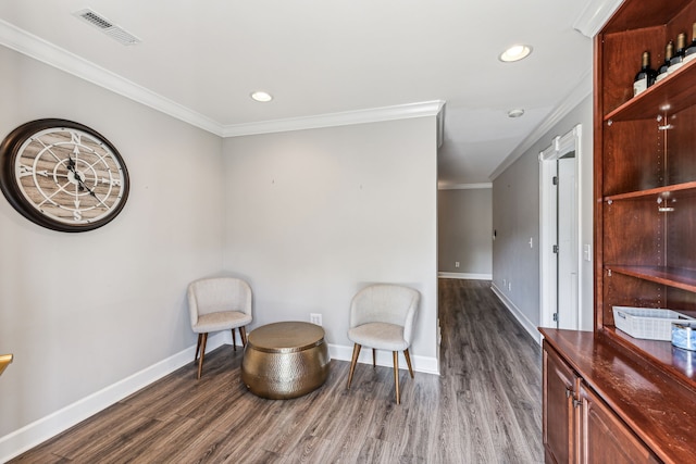 living area featuring ornamental molding and dark hardwood / wood-style flooring