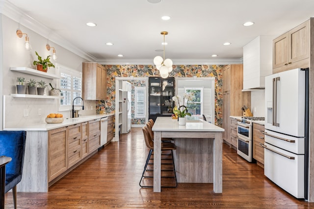 kitchen featuring light brown cabinets, a kitchen island, dark wood-type flooring, pendant lighting, and premium appliances