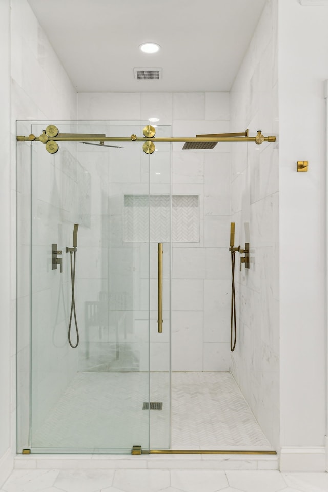 bathroom with a shower with shower door