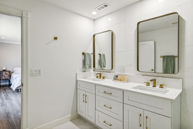 bathroom featuring vanity, crown molding, and hardwood / wood-style floors