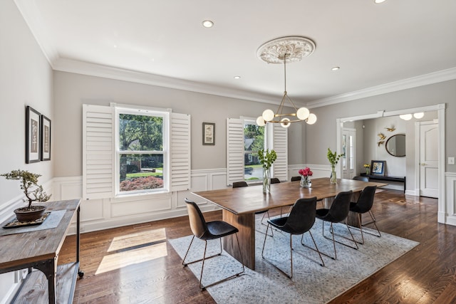 dining room featuring ornamental molding, dark hardwood / wood-style floors, and an inviting chandelier