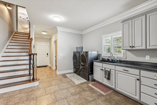 washroom featuring cabinets, light tile patterned floors, separate washer and dryer, ornamental molding, and sink