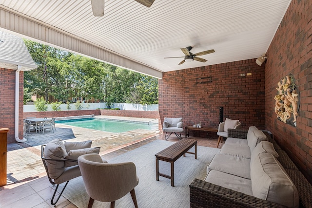 view of pool featuring outdoor lounge area, a patio, and ceiling fan