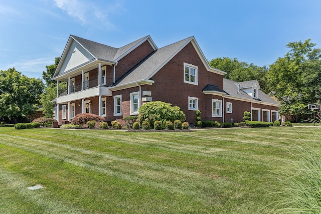 view of side of property with a lawn