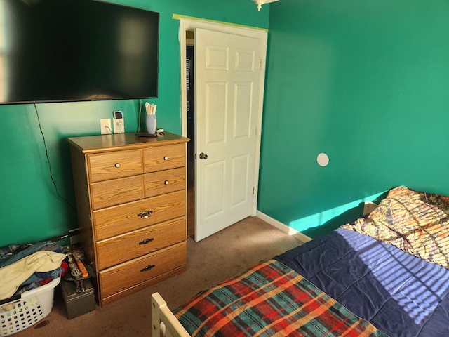 bedroom with dark colored carpet