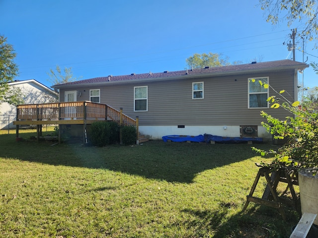 back of house featuring a deck and a lawn