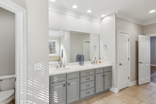 bathroom featuring vanity, crown molding, and toilet