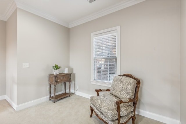 sitting room with ornamental molding and light colored carpet