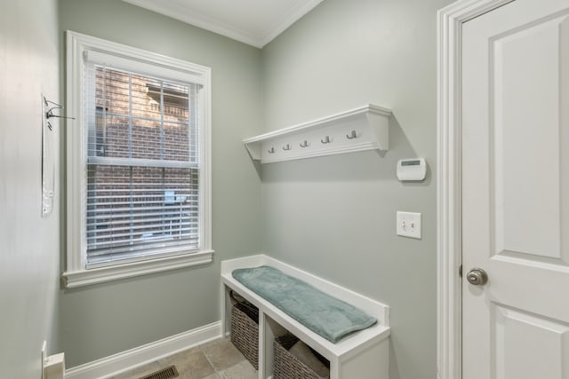 mudroom with ornamental molding and light tile patterned flooring