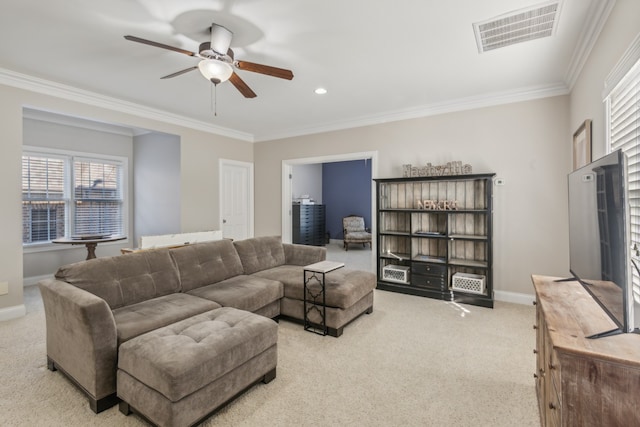 living room featuring crown molding, light carpet, and ceiling fan