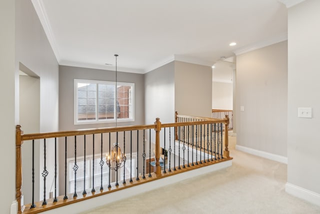 hallway featuring a notable chandelier, carpet flooring, and ornamental molding