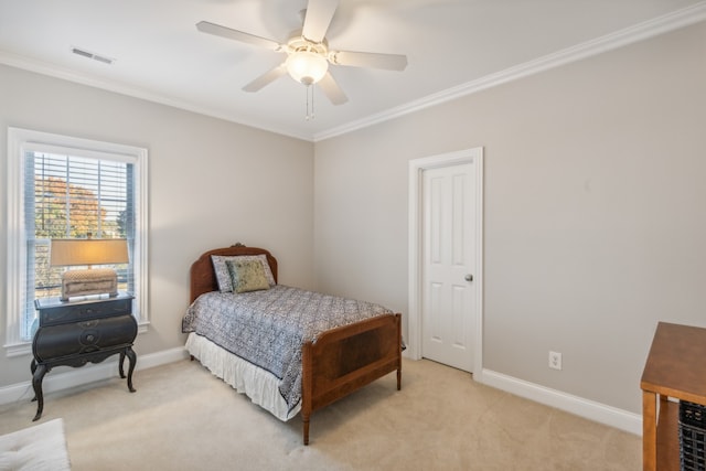 carpeted bedroom with ceiling fan and ornamental molding