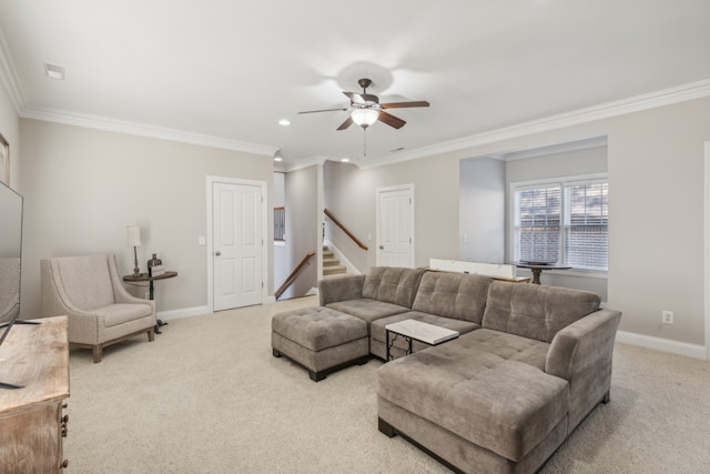 carpeted living room with ornamental molding and ceiling fan