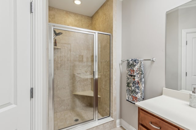 bathroom featuring vanity and a shower with shower door