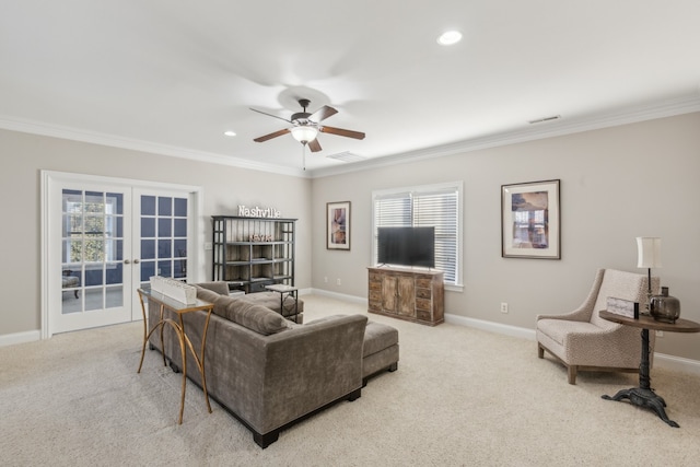 carpeted living room featuring french doors, a healthy amount of sunlight, and crown molding