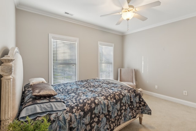 carpeted bedroom with crown molding and ceiling fan