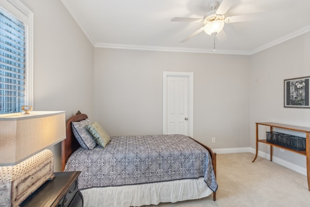 carpeted bedroom with crown molding and ceiling fan