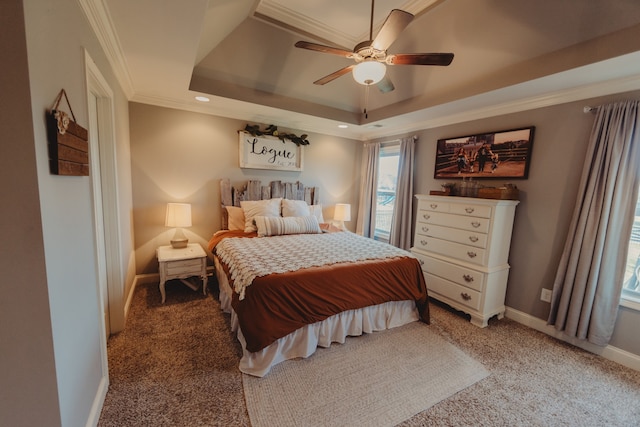 carpeted bedroom with ceiling fan, a raised ceiling, and ornamental molding