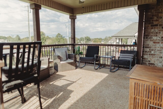 wooden terrace with an outdoor living space