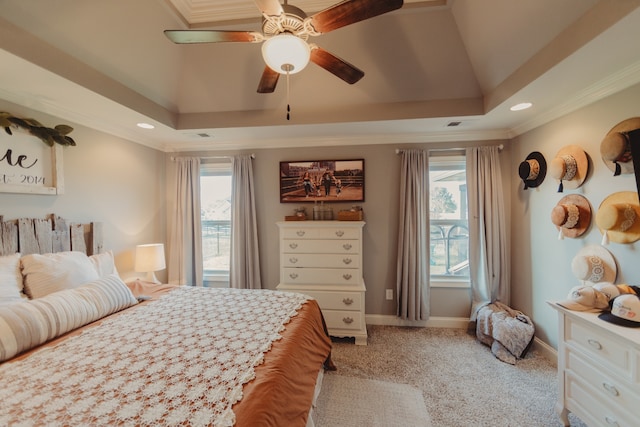 bedroom featuring ceiling fan, crown molding, multiple windows, and light colored carpet