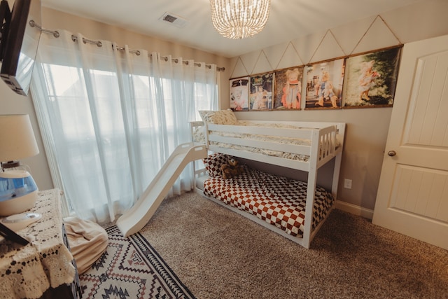 bedroom with carpet and an inviting chandelier