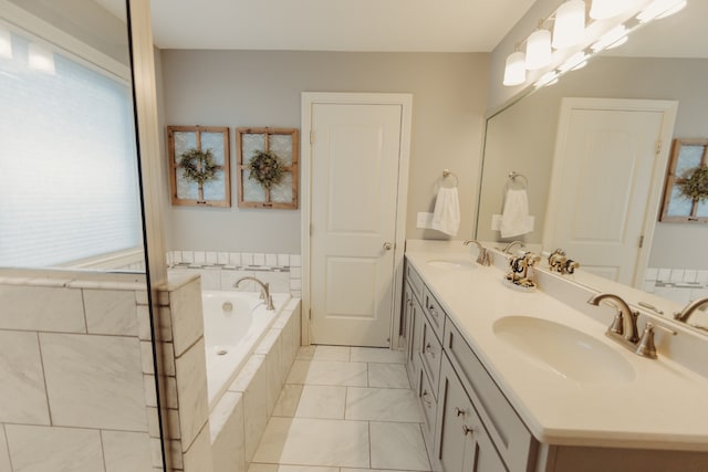 bathroom with vanity and a relaxing tiled tub