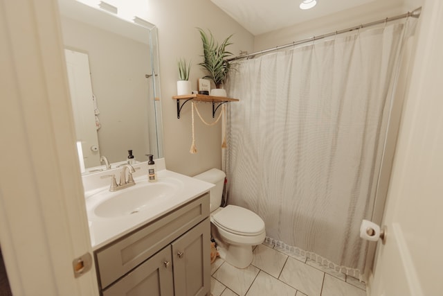 bathroom with vanity, curtained shower, toilet, and tile patterned flooring