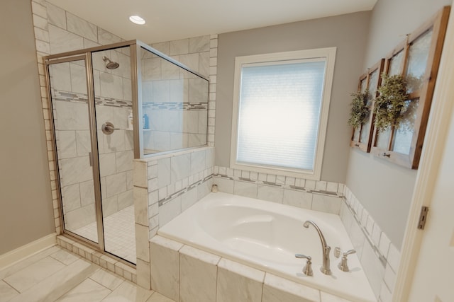 bathroom featuring separate shower and tub