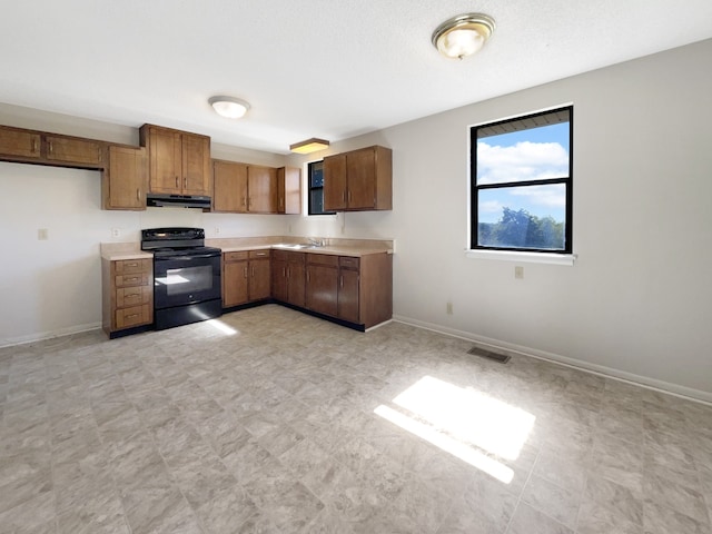 kitchen with black range with electric stovetop and sink