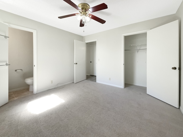 unfurnished bedroom with connected bathroom, light carpet, a closet, and ceiling fan