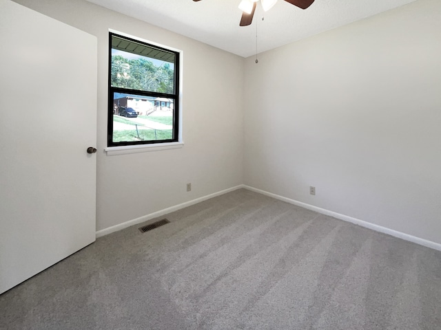 carpeted spare room featuring ceiling fan