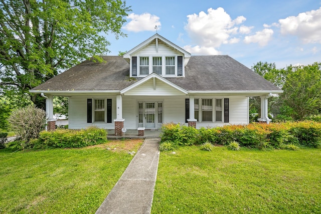 view of front of property with a front yard and covered porch