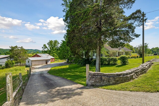 361 New Middleton Hwy, Gordonsville, TN 38563 - view of property hidden behind natural elements featuring driveway, fence, a garage, and a front yard