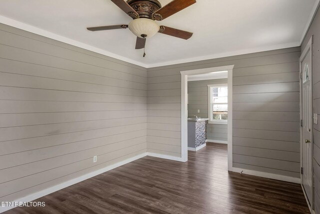 131 Christie Cir, Red Boiling Springs, TN 37150 - unfurnished room with dark wood finished floors, wooden walls, baseboards, and ceiling fan