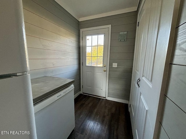 doorway to outside with wooden walls and dark wood-type flooring