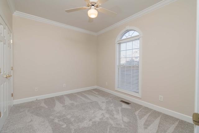 carpeted empty room featuring crown molding and ceiling fan