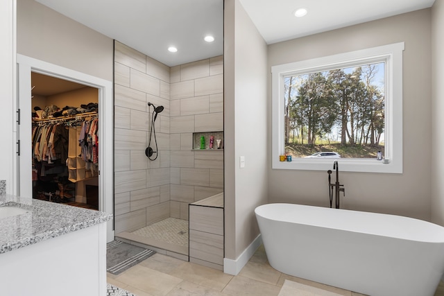 bathroom with vanity and independent shower and bath